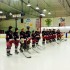 The Varsity Redhawk players listen to Central junior Brianna Reilly sing the national anthem before the start of the game.