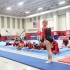 Senior Emily Hufferd anticipates her vault as her teammates watch on.