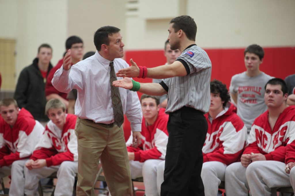 Head wrestling coach Rob Porter argues with an official, claiming that one of his wrestlers was illegally choked. The referee called the match in favor of sophomore Ben Williamsons opponent. Central would lose their DuPage conference opener, 32-26.