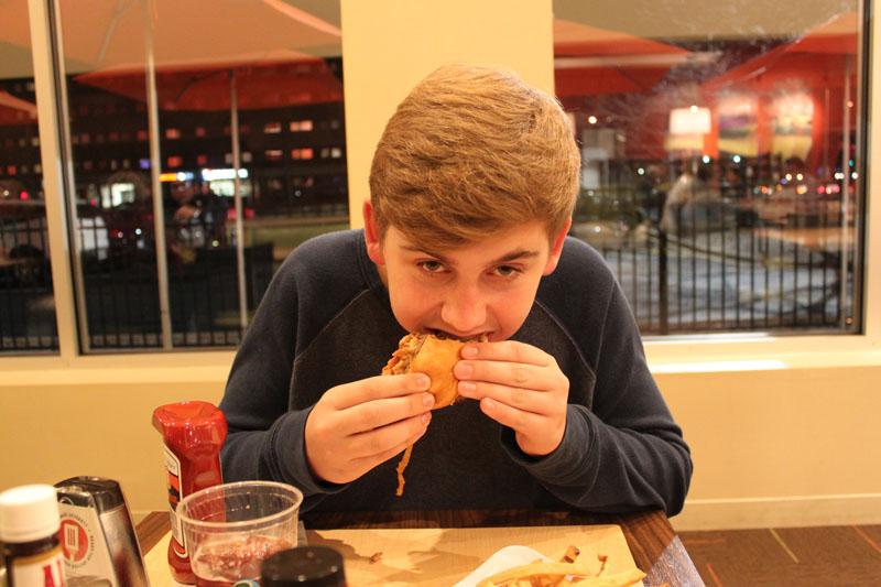 Junior Drew Quiriconi bites into his burger