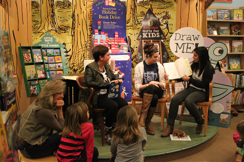 Members of Theatre Central read books aloud to visitors in the children's section of Barnes & Noble.
