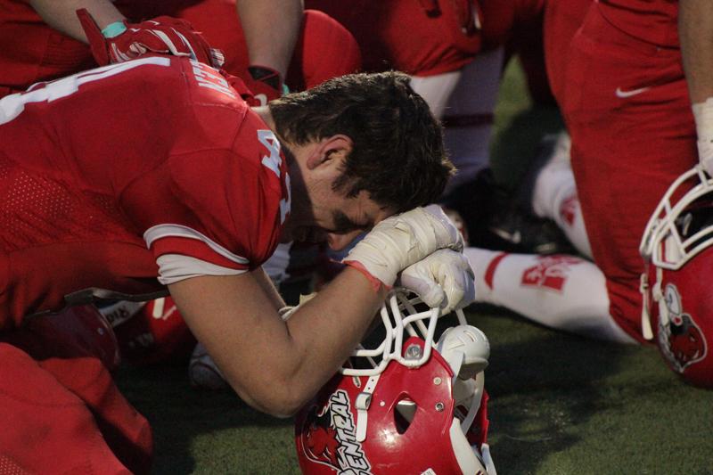 Bobby McMillen kneels in disappointment after the game.