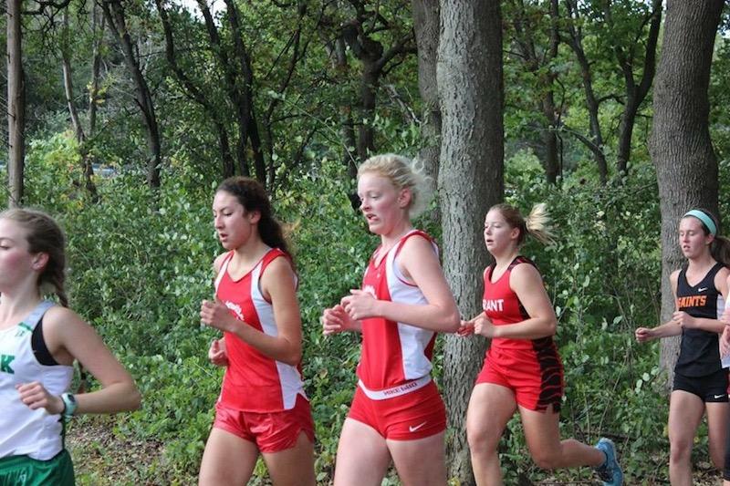 Senior Caitlin Ward, center, runs with other members of Centrals cross country team
