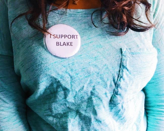 In this staged photo, a Central student wears an I support Blake pin on her chest. Several students were instructed to remove or hand over the buttons.