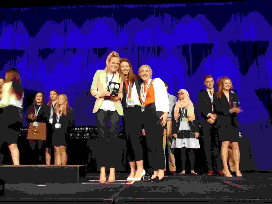 Seniors Mira Piucci, Katie Hunt and Hattie Goodwin pose with their awards at the DECA state competition.
