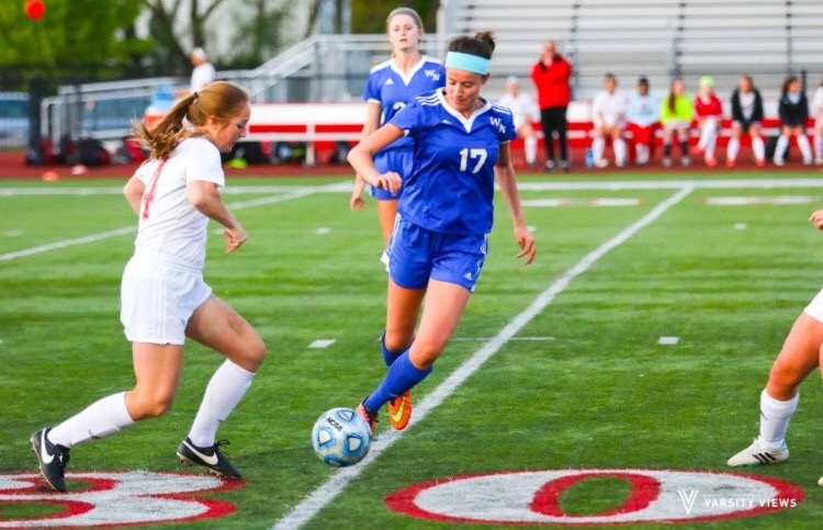 FANCY FOOTWORK: Meridith Hannan steals the ball from a Wheaton  North soccer player at a victorious home game on May 5, 2016.