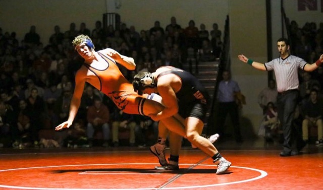 REGULATING WRESTLING: Christian Nussbaum tackles his opponent, winning the crosstown match held at Central on January 7, 2016. 