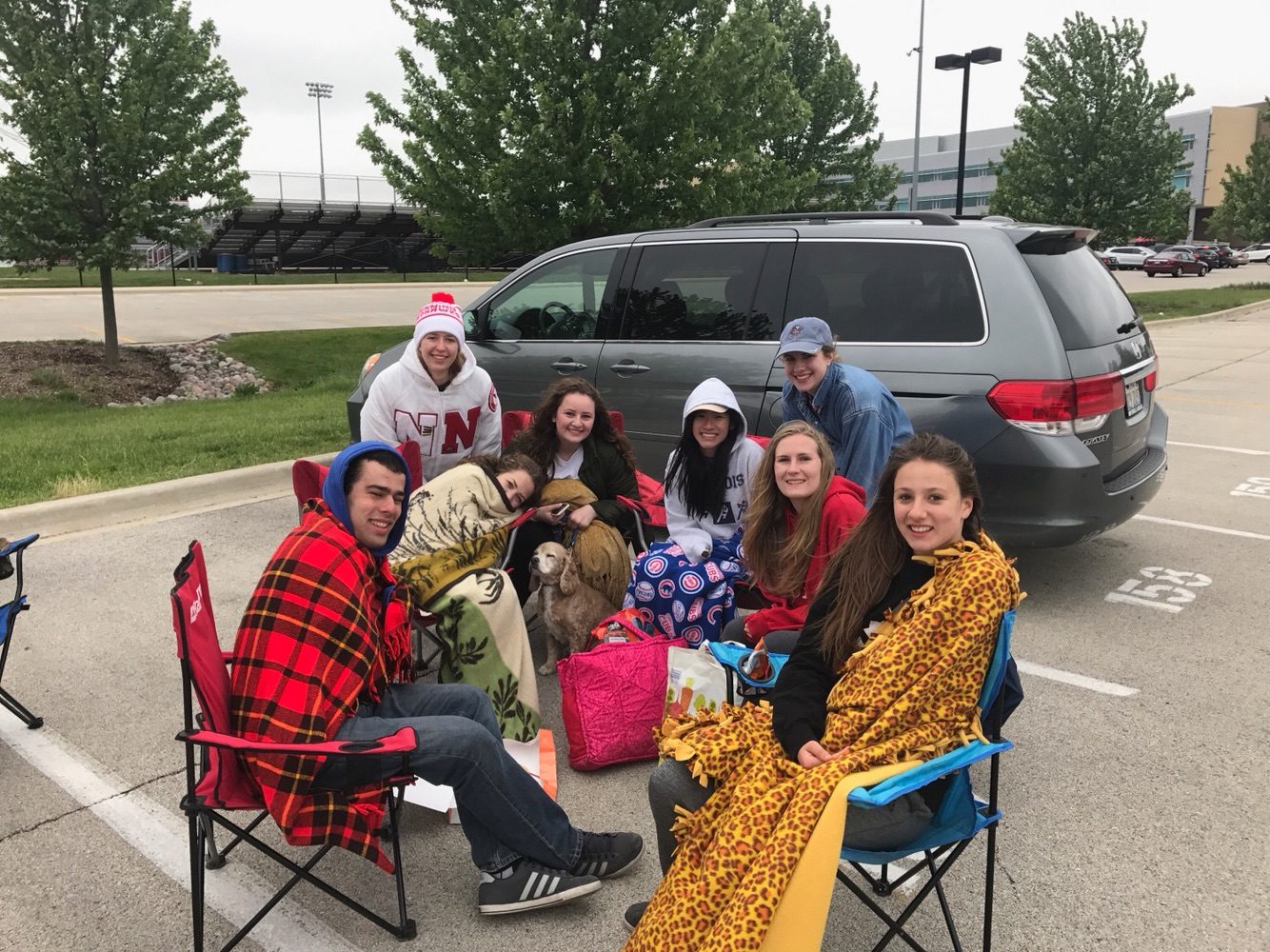 Seniors Aaron Gearhart, Rachel Damge, Anna Loveless, Angela Adamo, Max the dog, Lauren Kainrath, Jane Szymanski, Virginia Aabram and Mary Kelly sit in the senior lot, blocking parking spots and preventing underclassmen from parking.