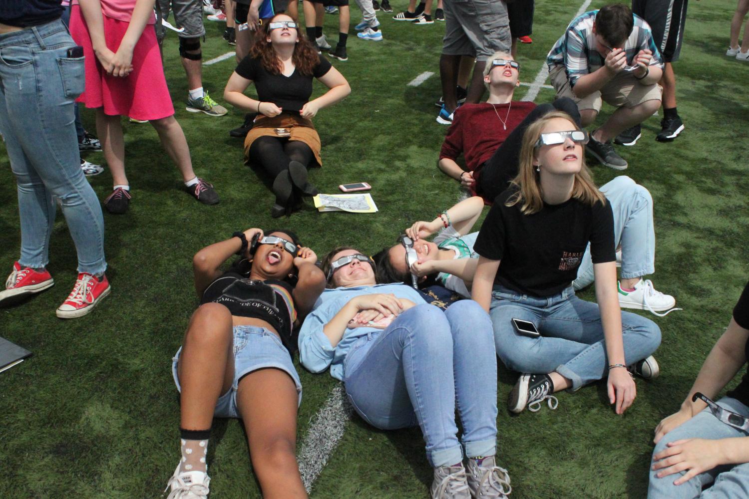 Central students gather on the football field to view the eclipse using the special eclipse glasses purchased for them by Home and School