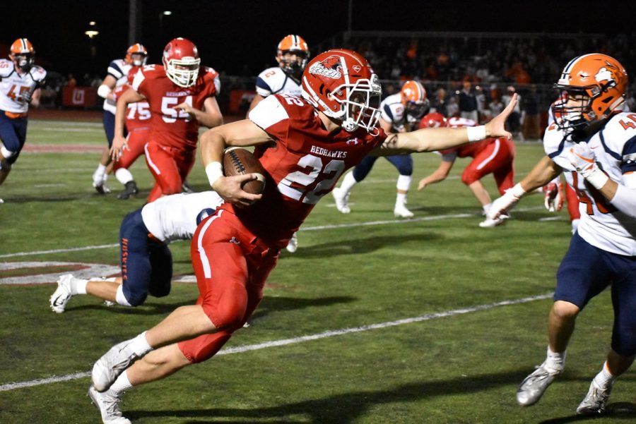 Senior Danny Hughes blocks Sean Doyle at the home game against Naperville North on Sept. 7.
