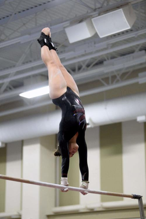 Senior Maddie Surin competes on the uneven bars at a home meet during her sophomore year.