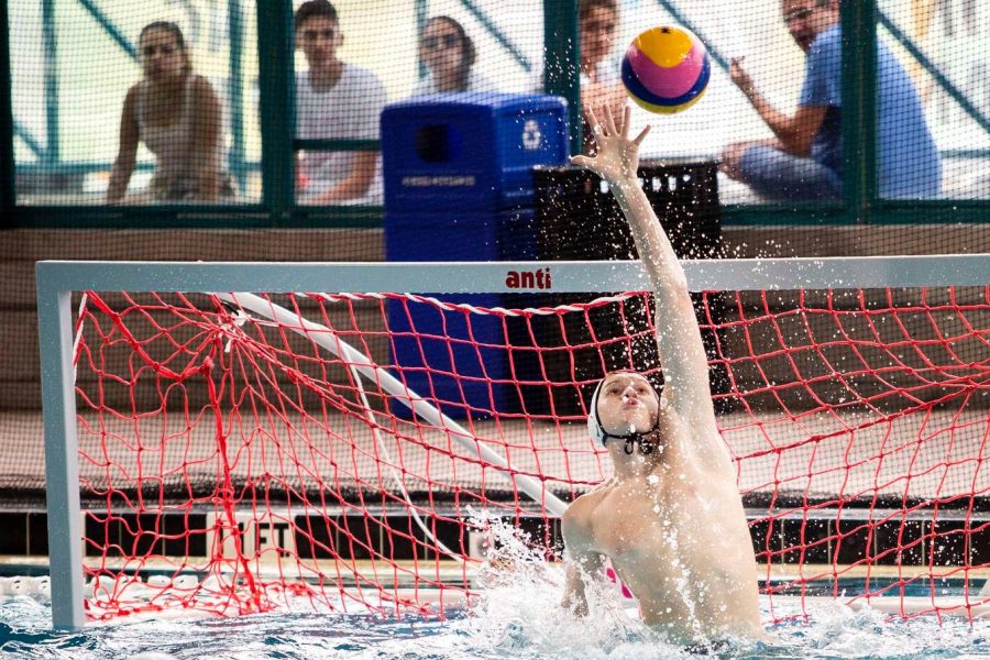 Senior Kent Emden jumping to block a high shot on his home goal.
