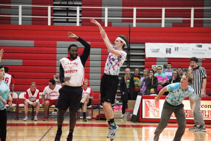 Senior Brian Clune attempts to make a basket during staff versus student basketball game on March 6 at Naperville Central.
