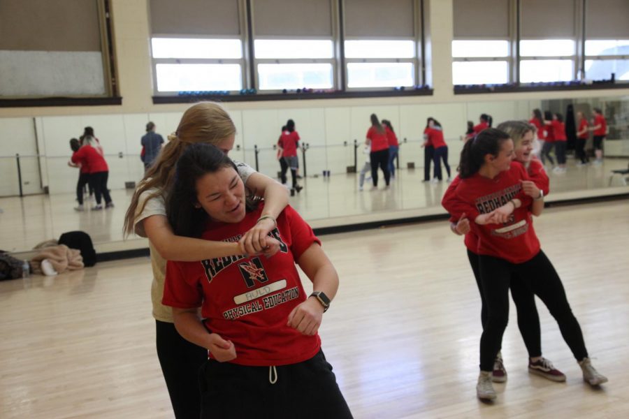 Seniors Julia Tung and Emilie Mineo defend themselves in a simulated attack. “I feel much more prepared and confident heading off to college next year,” Tung said. “This class has taught me a lot of helpful self-defense techniques.”