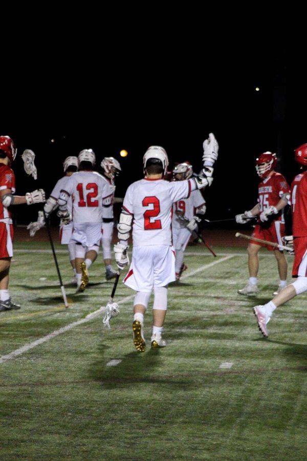 Freshman Evan Amato (2) scores at the home game against Hinsdale Central on March 18. Later in the game, the starting attacker tore his ACL.
