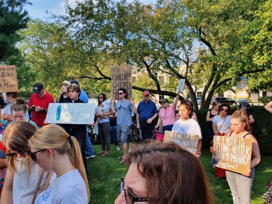 Strikers raise their signs in preparation for the speakers