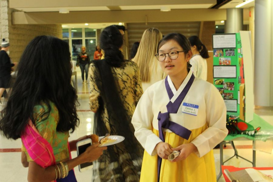 Senior Emma Lim presents at the South Korea booth.
