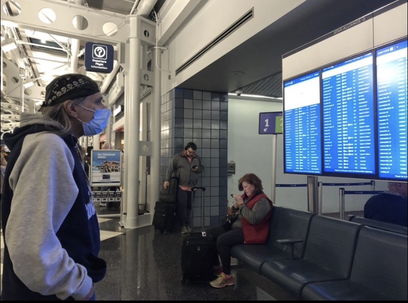 A traveler at O’Hare International Airport wears a mask as he waits for his flight on Feb 13. Many are taking precautions against the spread of coronavirus. 