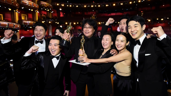 The cast of Parasite poses for a photo at the Oscars after becoming the first foreign film to win Best Picture