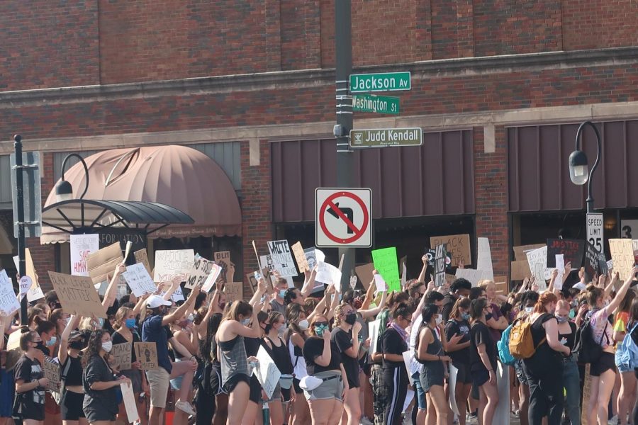 Protesters cross Jackson Avenue on Washington Street in downtown Naperville during a Black Lives Matter rally on June 4.