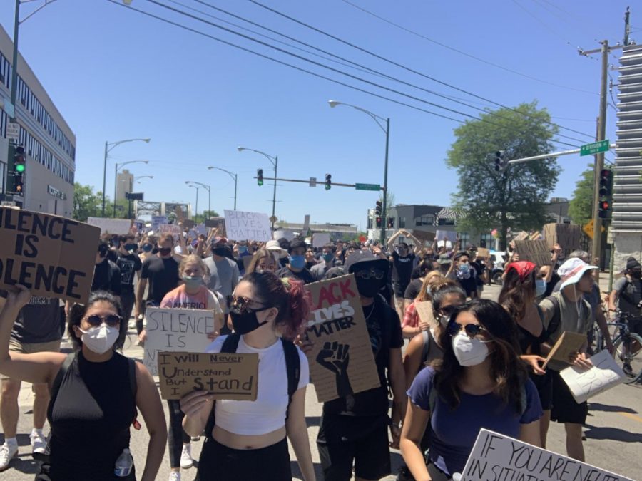 Protesters in Chicago hold signs and chant to demand justice for George Floyd and the black community