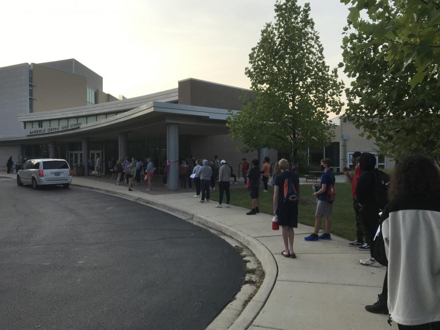 Socially distanced seniors wait in line to enter the school and make up their spring SAT on Sept. 23. 