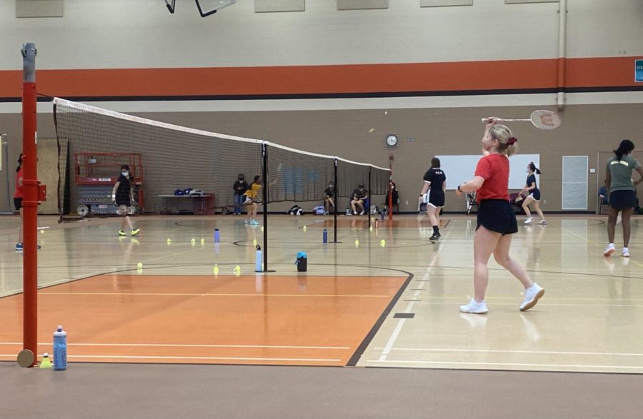 Sophomore junior varsity player Claire Furibondo prepares to receive an incoming shot at a match on March 19.