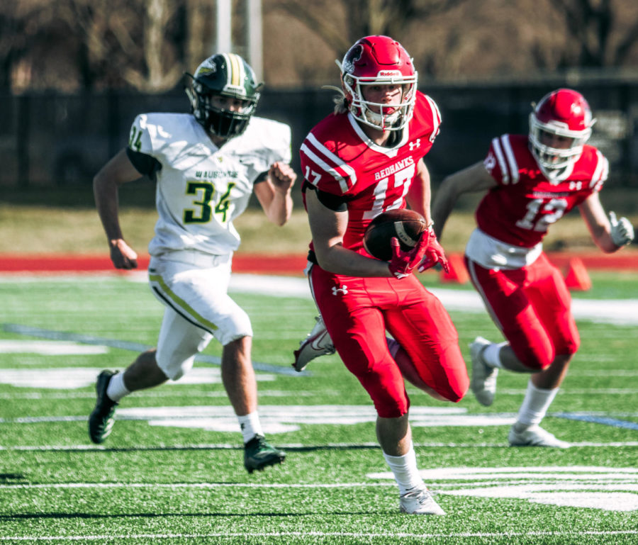Junior wide receiver Luke Roy shakes off the defense in a game against DVC rival Waubonsie Valley on March 20. 