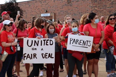 Educators, parents and students rally outside of the Washington Junior High School main entrance in support of the Naperville Unit Education Associations contract proposal on Aug. 2. 