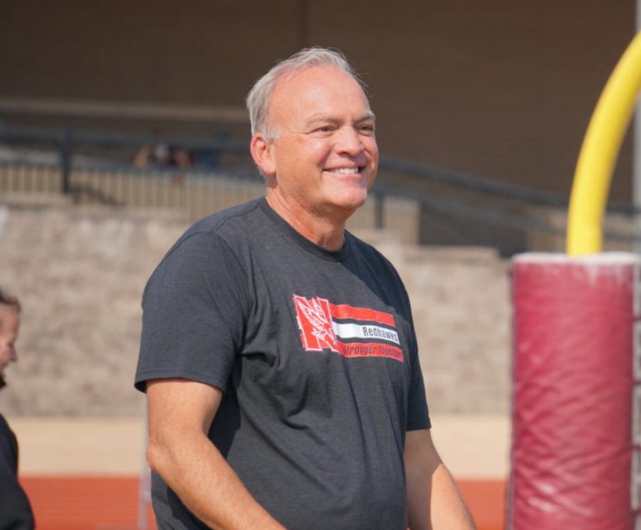 Principal Bill Wiesbrook smiles to the crowd as they sing "Happy Birthday" to him at the homecoming assembly on Friday, Oct. 1 following his retirement announcement. 