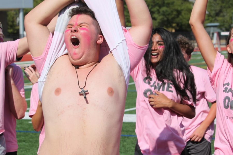 Sophomore Ben Crowley lifts his shirt as the stands cheer.