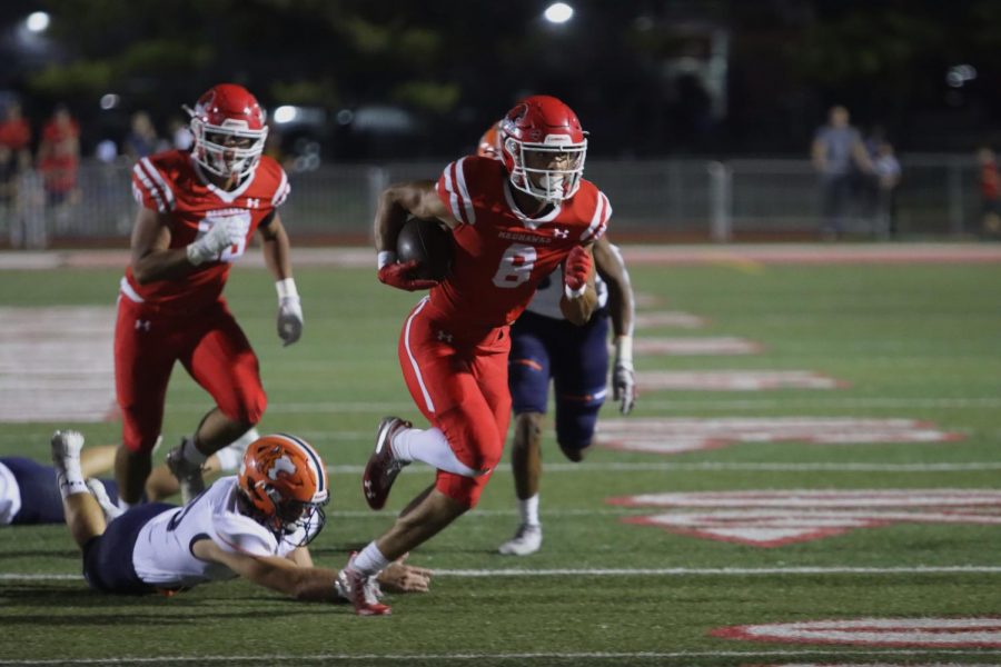 Senior wide receiver Reggie Fleurima breaks through defenders to score a touchdown in the first quarter. 