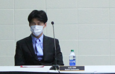 Senior Uju Kim listens to a speaker at the board meeting on Nov. 15.