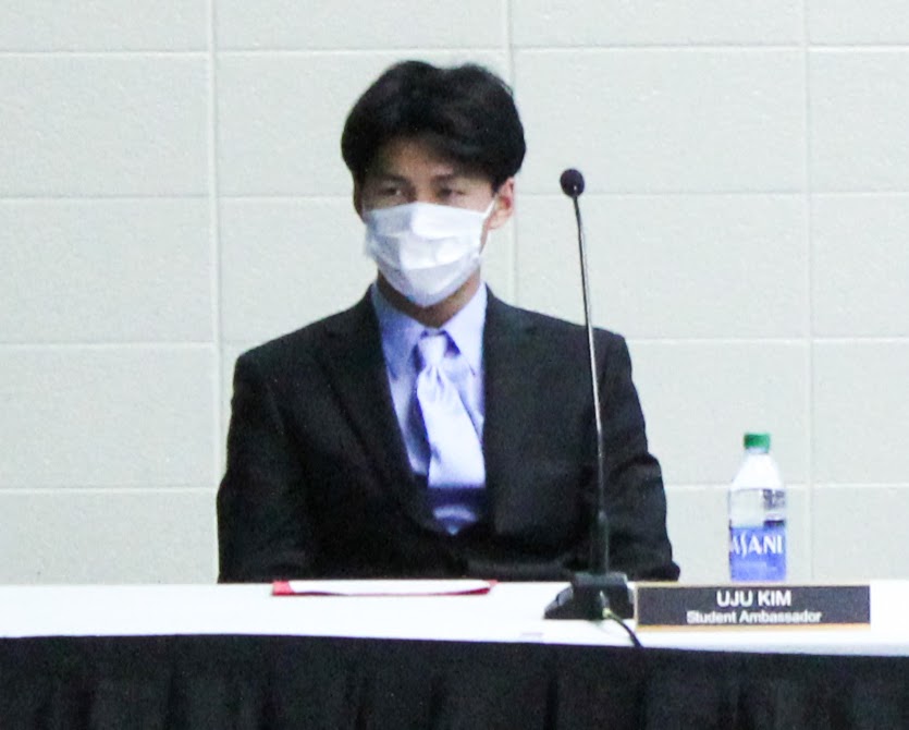 Senior Uju Kim listens to a speaker at the board meeting on Nov. 15. 