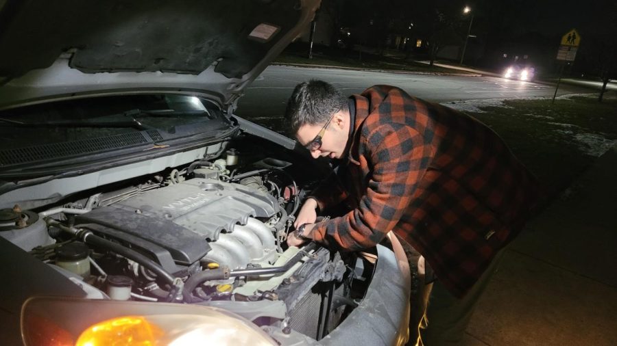 Ramy+Alnass+working+on+the+radiator+of+his+Toyota+Matrix+XRS.