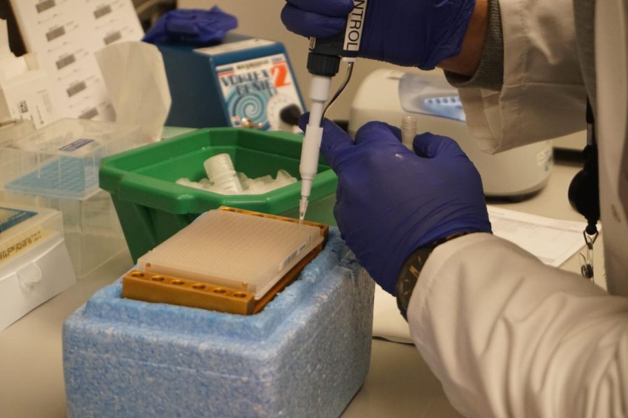 Lab technologist Hussein Hassanein adds the negative control to a plate of samples. A multitude of quality assurance measures increase the accuracy of SHIELD tests, however, without a positive retest policy, the rate of false positives may increase greatly. At a 1.6% positivity rate, the most up-to-date numbers for District 203, a graph by University of Illinois epidemiologist Rebecca Lee Smith shows that as much as 40%, if not more, of positive results may be false.