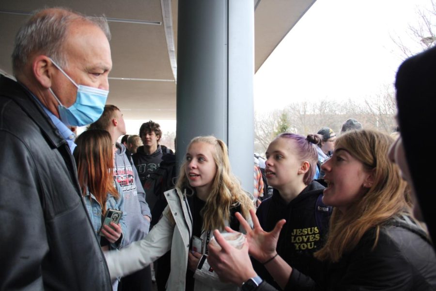 Principal Bill Wiesbrook speaks to students protesting the mask mandate at the front entrance of Naperville Central on Feb. 9.