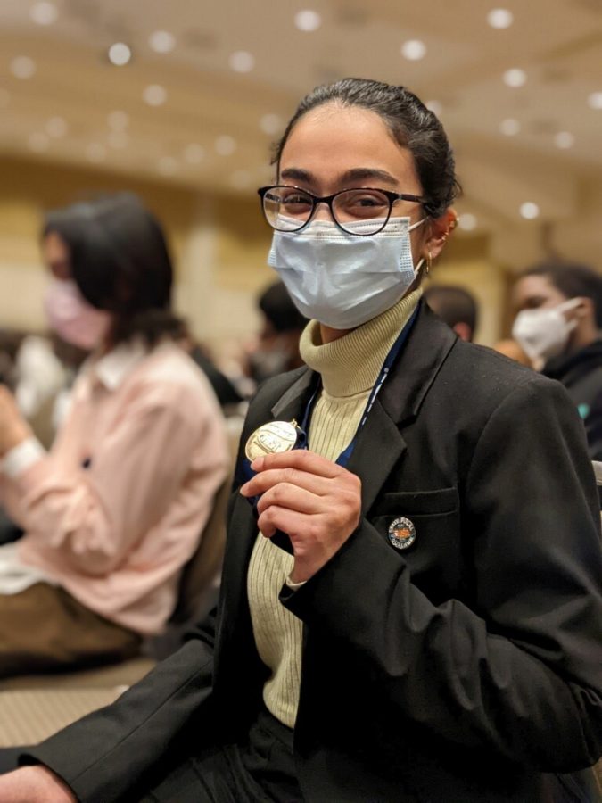 Senior Maryam Tariq shows off her first place medal after Radio Speaking winners were announced and she performed her piece on stage.