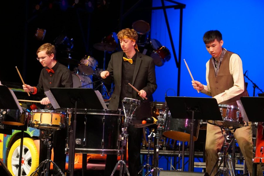 Left to right: junior Alex Remiasz, junior Brenden Speckman and senior Jeremy Chou playing on various instruments during a small ensemble piece at “NCHS Drumshow Rock 2022” April 9 in the auditorium. 