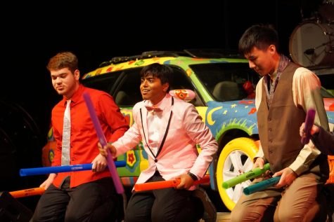 Right to left: senior Stephen Hoffman, junior Rohin Gopalka and senior Jeremy Chou play “Another One Bites the Dust/Stayin’ Alive” with boomwhackers, hollow tubes typically used in elementary classrooms made to produce specific pitches, at “NCHS Drumshow Rock 2022” April 9 in the auditorium. 