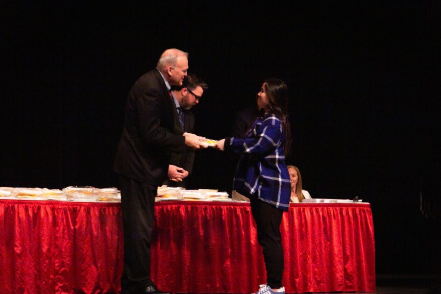 Senior Anna Chi receives an academic award at the senior awards ceremony.