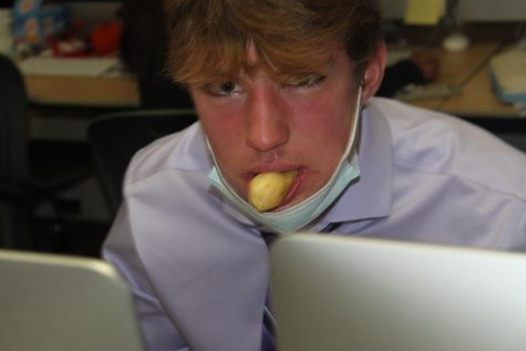 Senior Connor McHugh devours a breadstick in the Central times office. The image has since become a meme among the group.