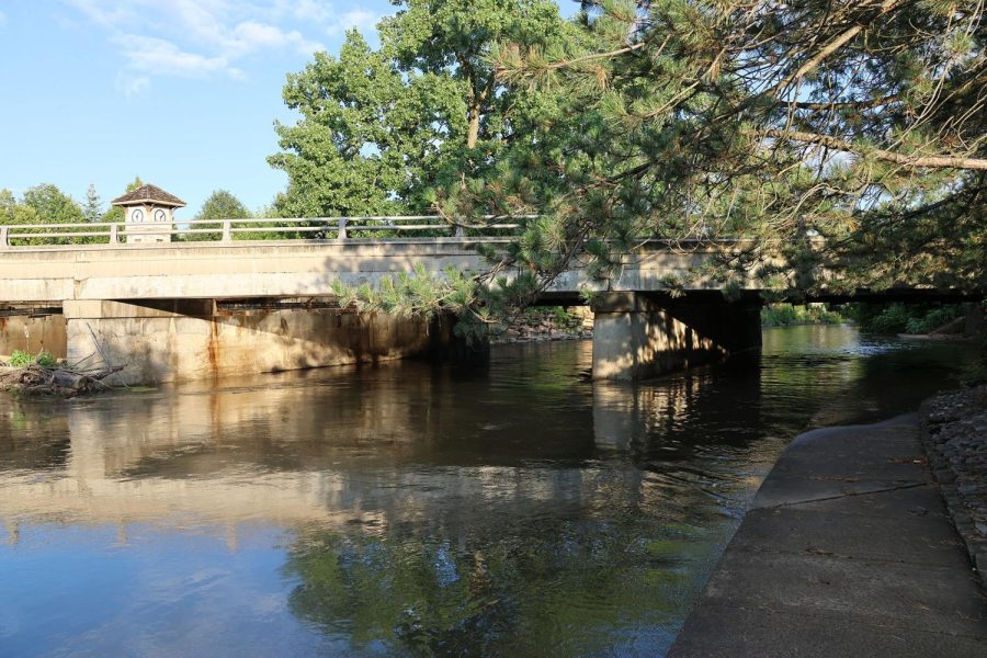 The DuPage River overflows onto the Naperville Riverwalk under the Washington Street bridge after heavy rains.