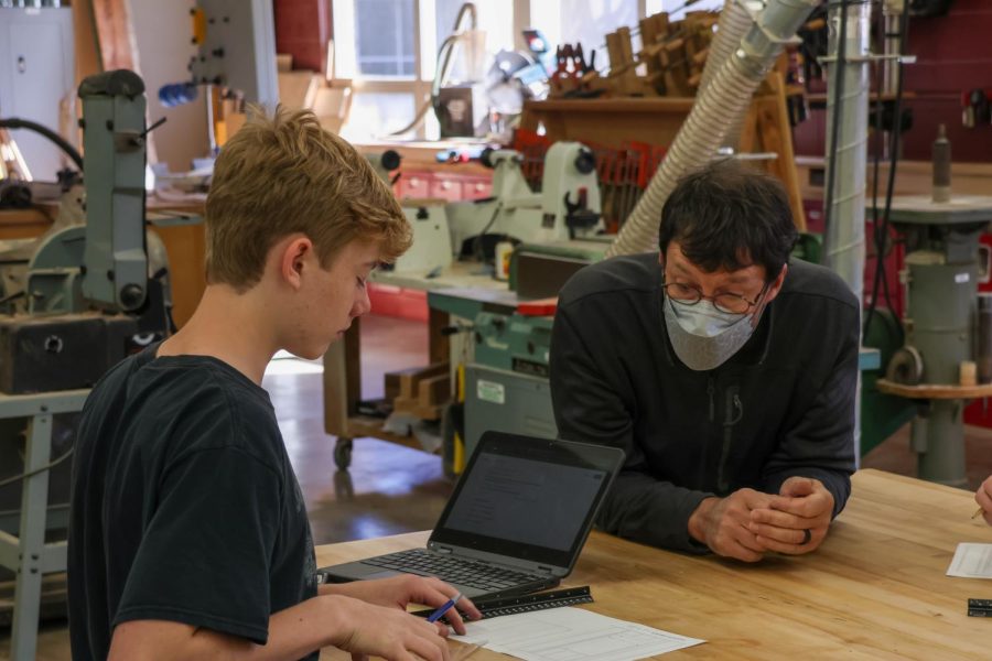 7: Central CTE teacher Wright King was named Illinois Tech High School Teacher of the Year. King “pushes, stretches, extends and inspires students in technology and engineering,” fellow CTE teacher Brett Thompson said. 
We chose this as our number 7 picture due to rich story this told. King is in the foreground instructing a student, but the fascinating background of his classroom helps establish him in his environment.