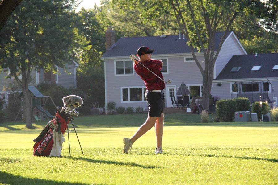 6: Redhawk junior Aidan Schulz nears the end of the 18th hole in a varsity match against rival Naperville North at Crest Creek Golf Course on Aug. 30.
The lighting of this shot heavily contributed to it being number six on the list: Schultzs shadow is contrasted against the bright grass, as light filters in through the leaves above.