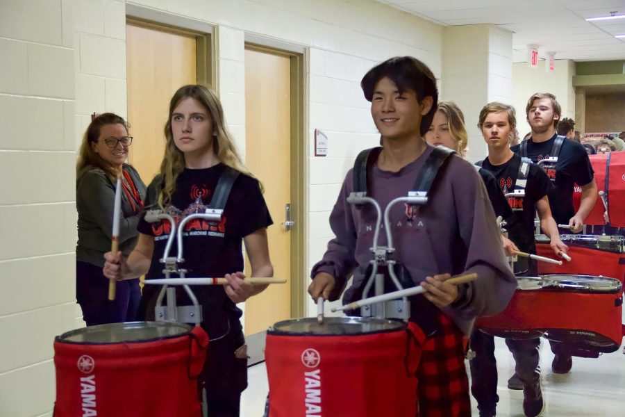 Seniors Kelsey Schneck (left) and Mark Park (right) lead Central’s drumline through the hallways during the first “State Walk” on Oct. 19.