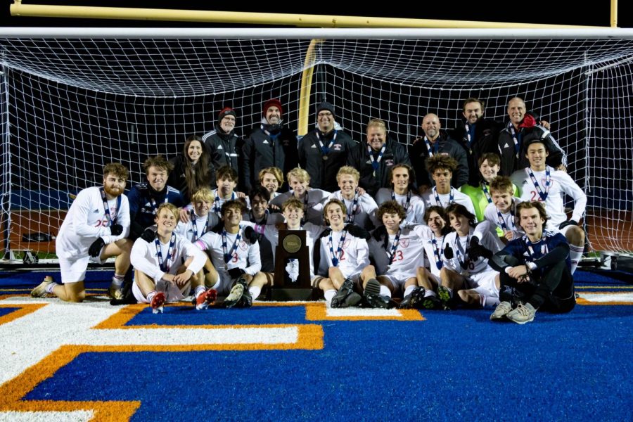 The+boys+soccer+team+poses+with+the+State+Championship+trophy+shortly+after+their+win+against+Romeoville+on+Nov.+5.