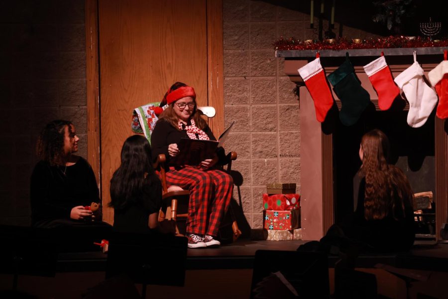 Lynne Nolan narrates the children’s book “The Night Before Christmas” as the Wind Ensemble performs the piece during the Winter Festival concert on Dec. 9. 