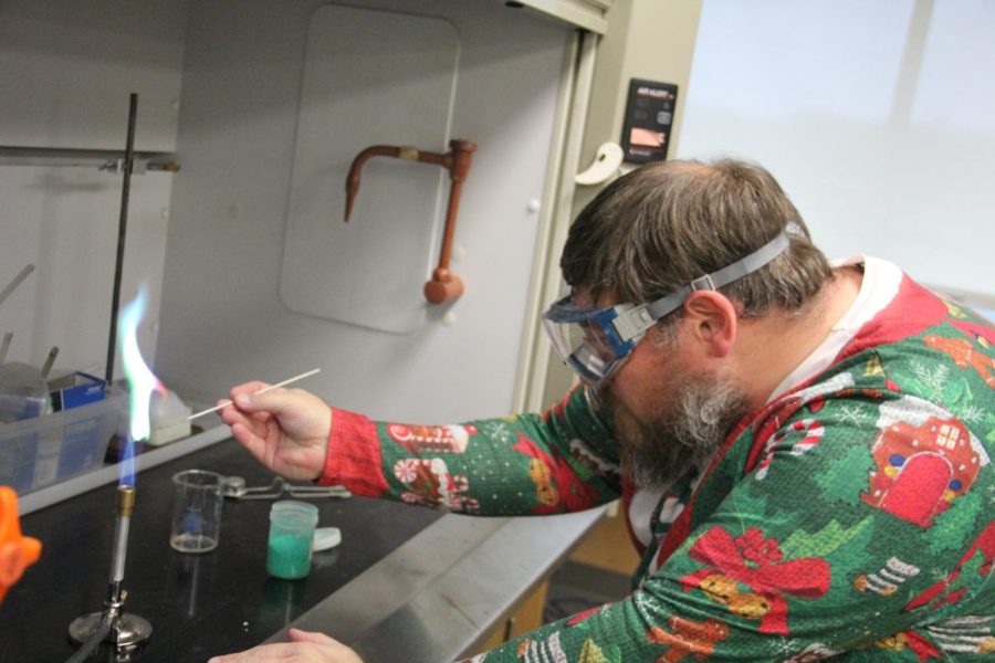 Chemistry teacher Jeromy Bentley starts a chemical reaction over his bunsen burner in his classroom lab. 