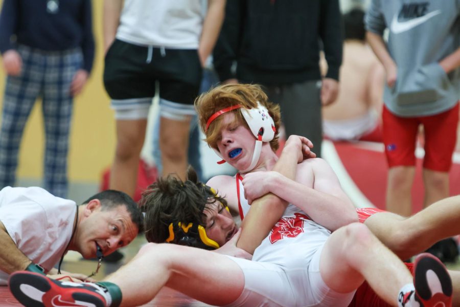Sophomore wrestler Quinn O'Donnell takes down teammate during Red and White varsity scrimmage on Nov. 18. 